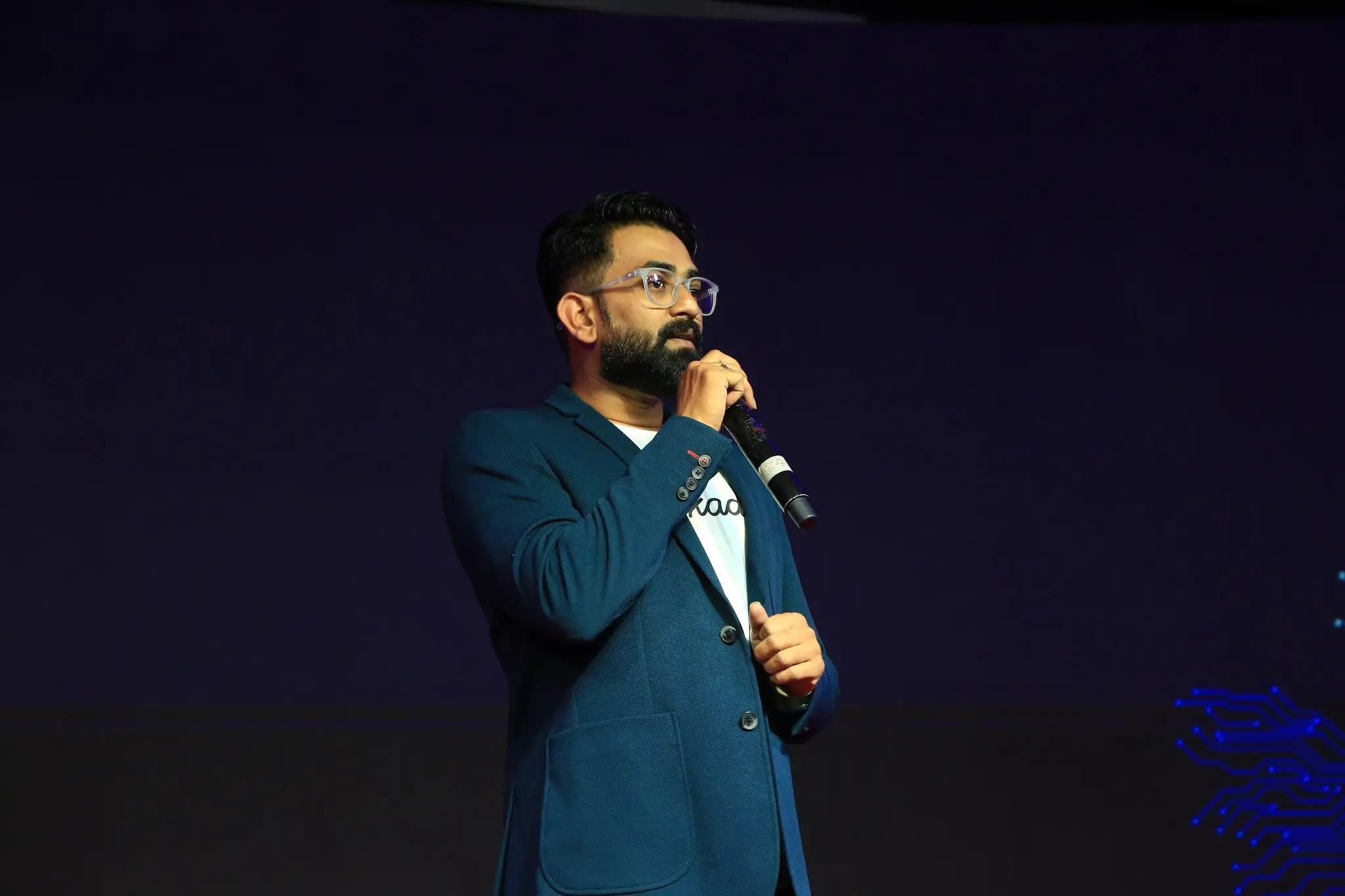 Rishant Kumar speaking on stage at a technology event