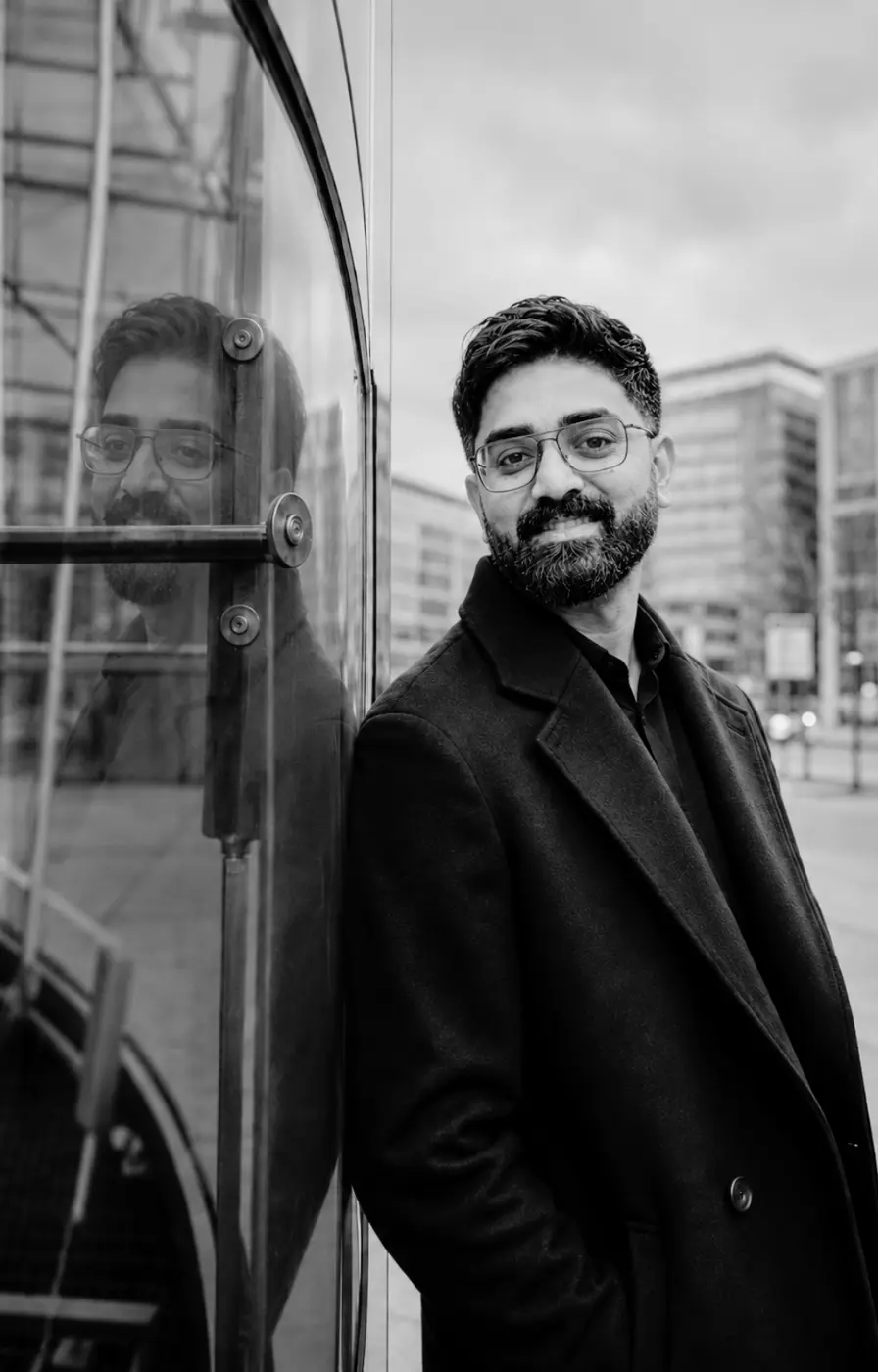 Portrait of Rishant Kumar in a modern urban setting